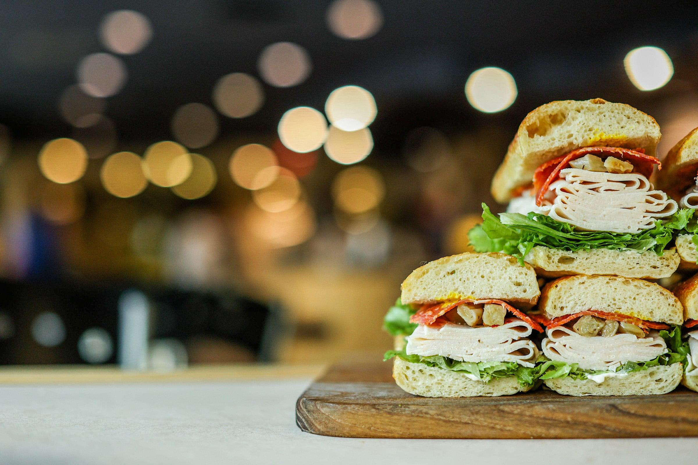 A display of sandwiches on a wooden board